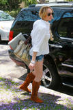 Lindsay Lohan with denim shorts and boots leaving Dior and walking in Beverly Hills